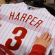 A jersey being lettered and prepared to send out to a Phillies fan.